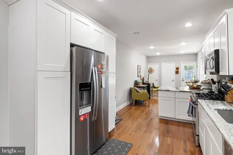 a kitchen with a refrigerator and a sink