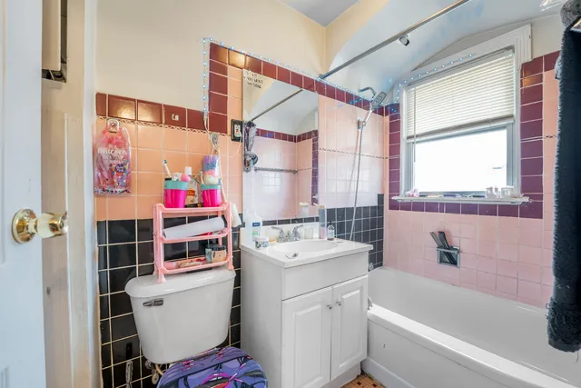 a bathroom with a sink toilet vanity and tub