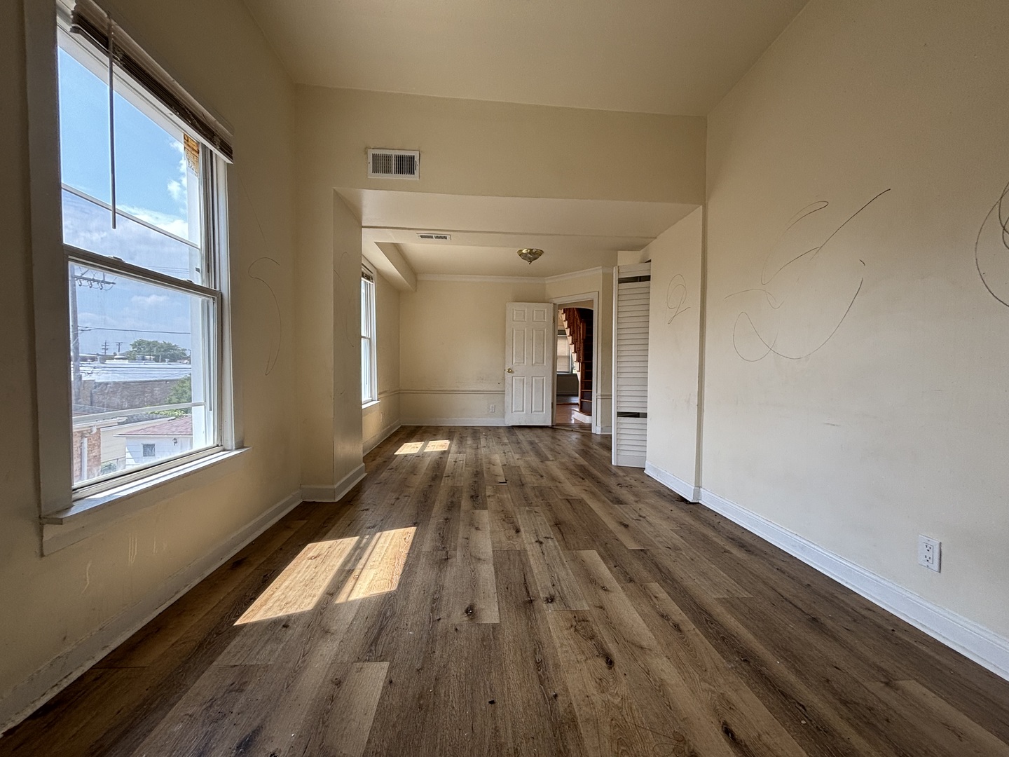 2530 North Neva Avenue Chicago, IL 60707 - Photo 13 of 50 a view of a room with wooden floor and large windows