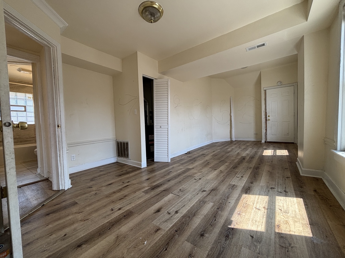 2530 North Neva Avenue Chicago, IL 60707 - Photo 14 of 50 an empty room with wooden floor and entrance