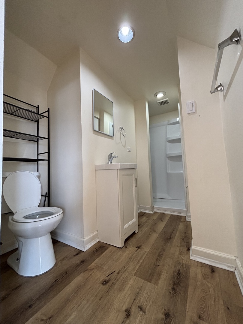 2530 North Neva Avenue Chicago, IL 60707 - Photo 20 of 50 a view of a bathroom with wooden floor and a toilet