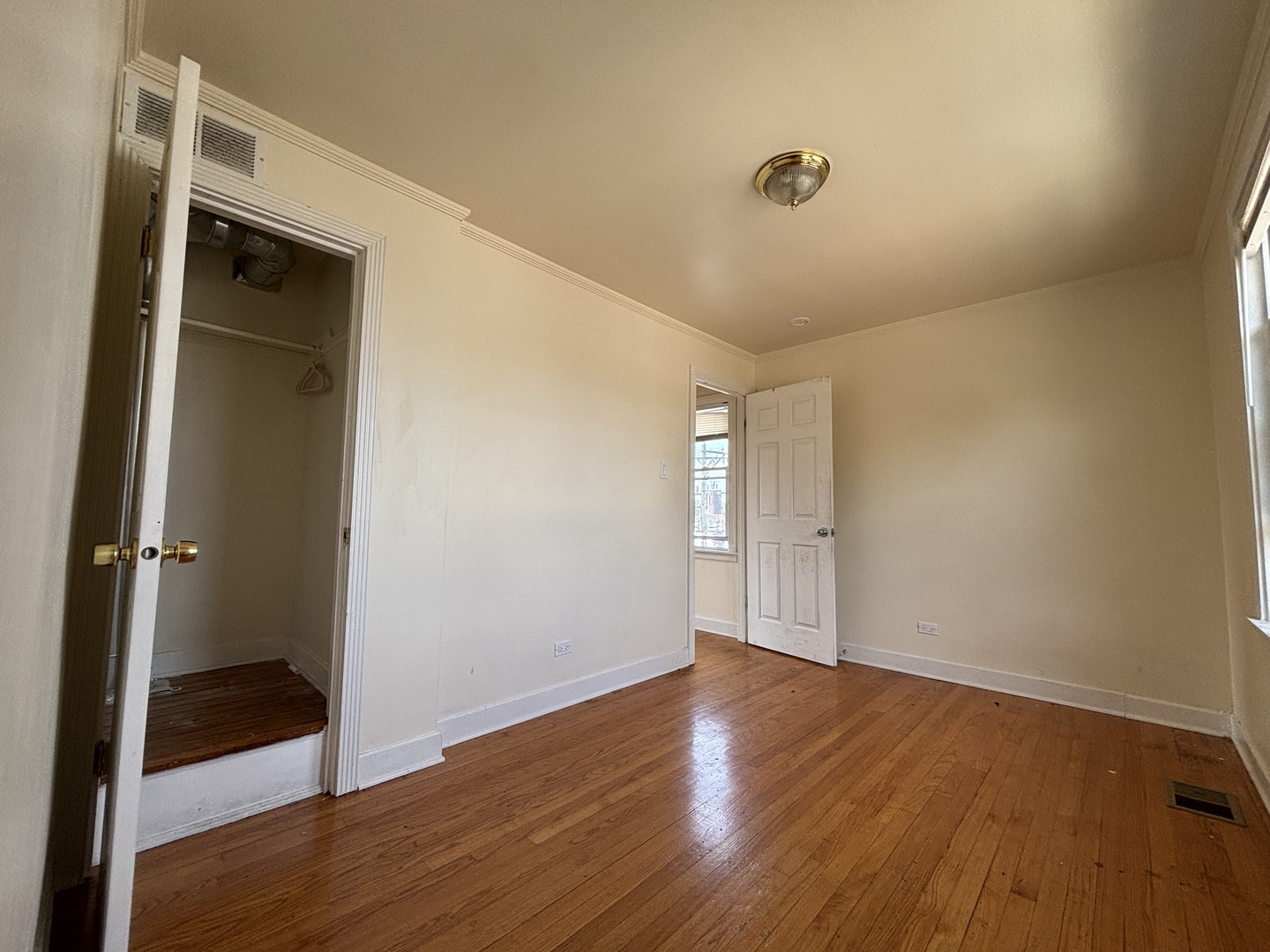 2530 North Neva Avenue Chicago, IL 60707 - Photo 21 of 50 a view of an empty room with wooden floor and closet