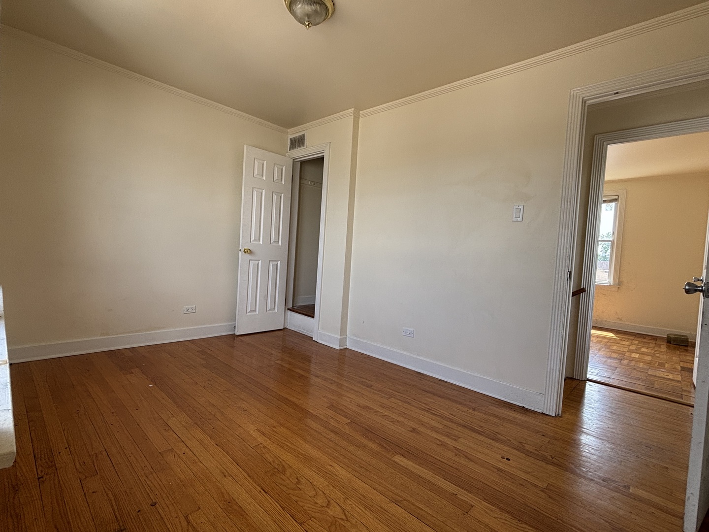 2530 North Neva Avenue Chicago, IL 60707 - Photo 22 of 50 a view of an empty room with wooden floor