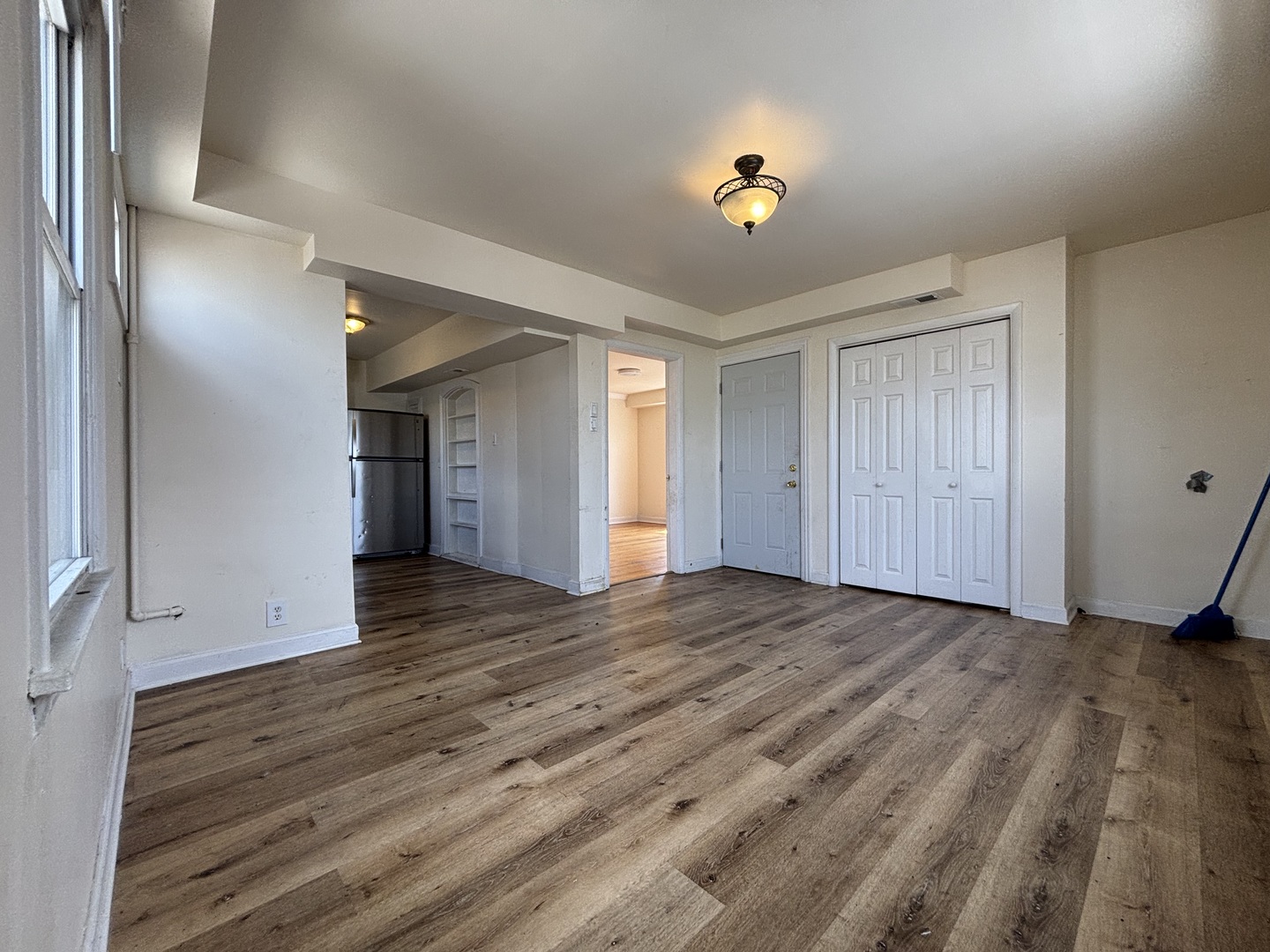 2530 North Neva Avenue Chicago, IL 60707 - Photo 24 of 50 a view of an empty room with wooden floor and a window
