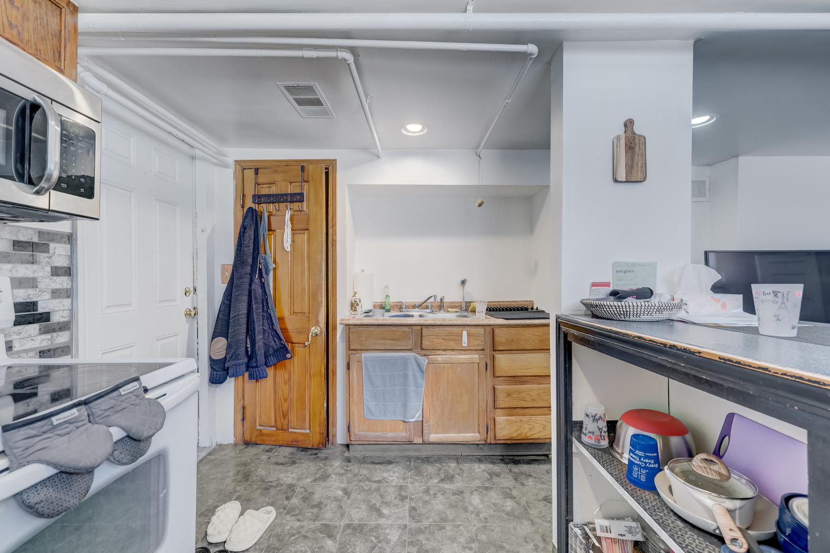 2530 North Neva Avenue Chicago, IL 60707 - Photo 28 of 50 a kitchen with stainless steel appliances granite countertop a sink and cabinets