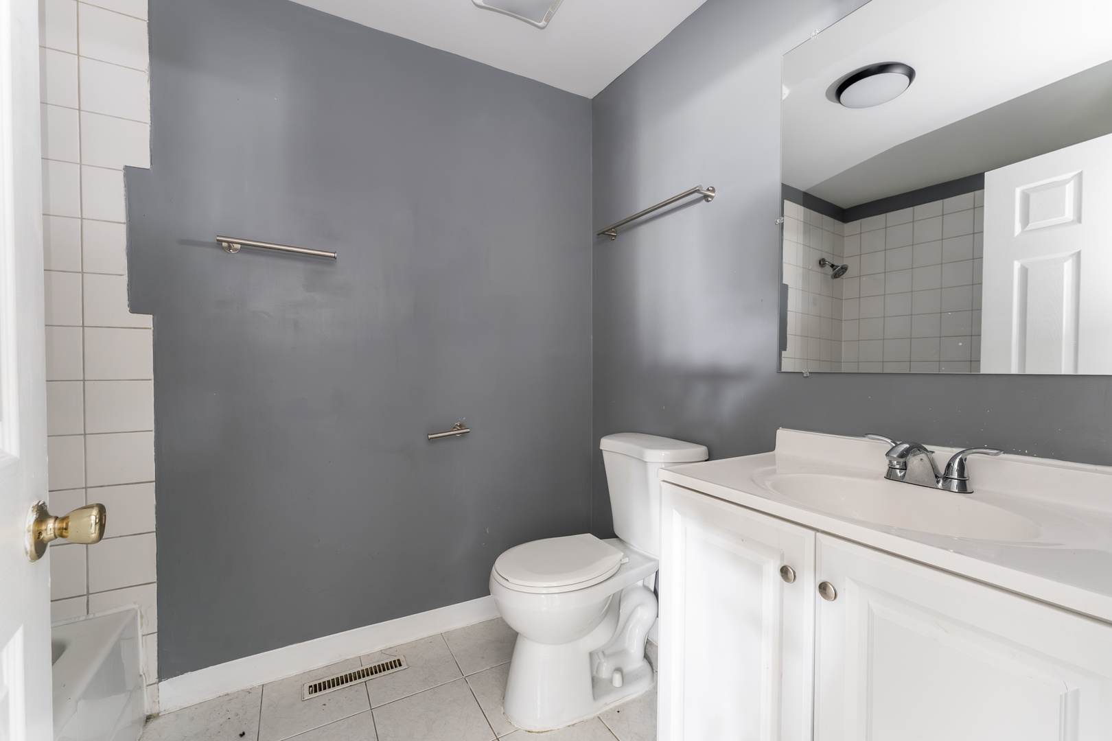 2530 North Neva Avenue Chicago, IL 60707 - Photo 40 of 50 a bathroom with a sink a toilet and a mirror