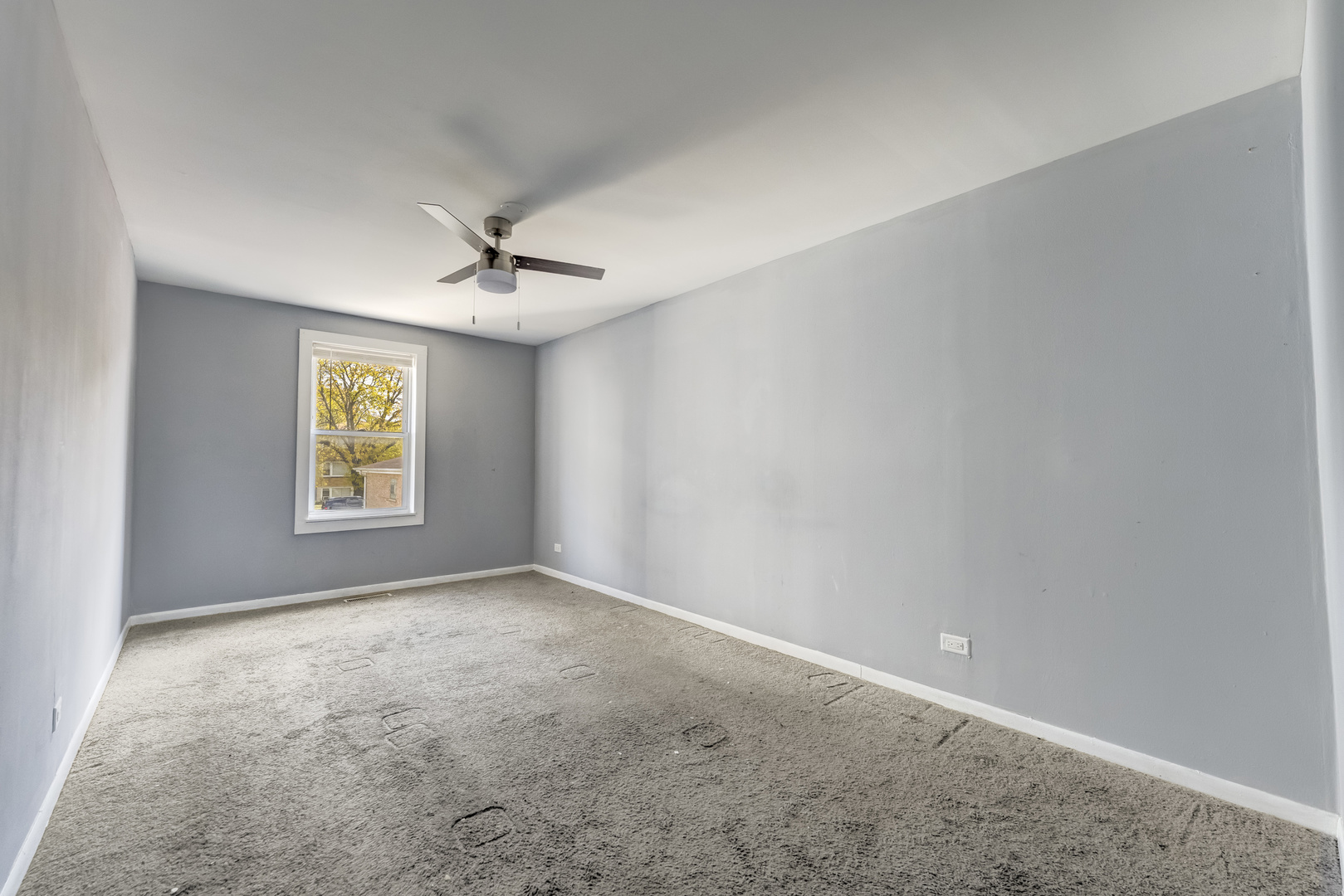 2530 North Neva Avenue Chicago, IL 60707 - Photo 41 of 50 an empty room with windows and ceiling fan