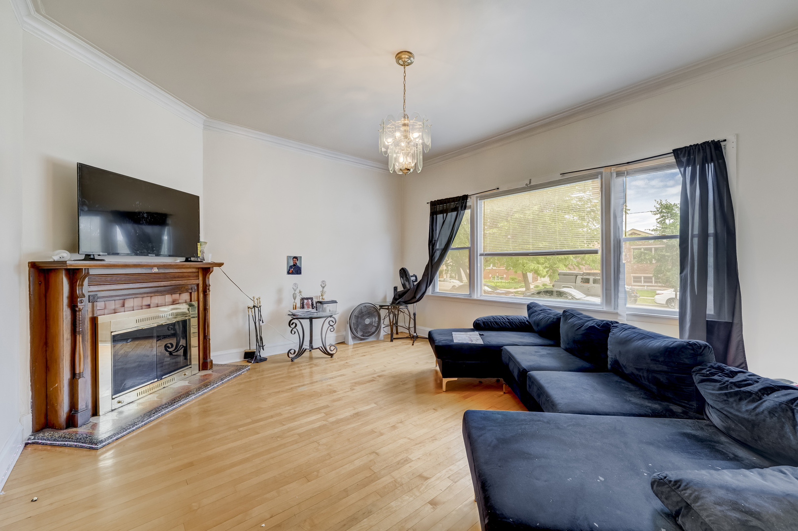 2530 North Neva Avenue Chicago, IL 60707 - Photo 5 of 50 a living room with furniture a fireplace and a flat screen tv