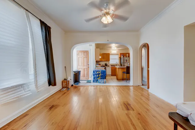 a view of a room with wooden floor gym equipment and windows
