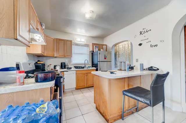 a kitchen with a sink appliances and cabinets
