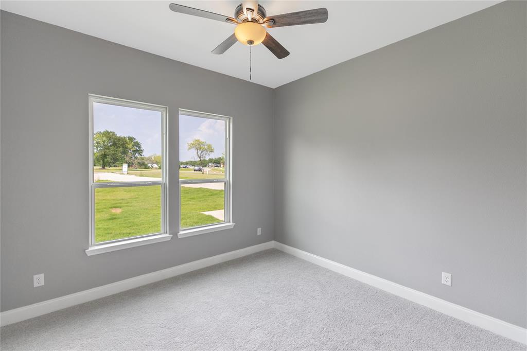 10560 Lago Vista Quinlan, TX 75474 - Photo 13 of 31 an empty room with windows and chandelier fan