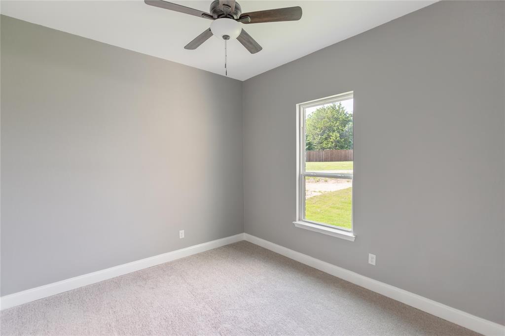 10560 Lago Vista Quinlan, TX 75474 - Photo 20 of 31 an empty room with a window and a fan
