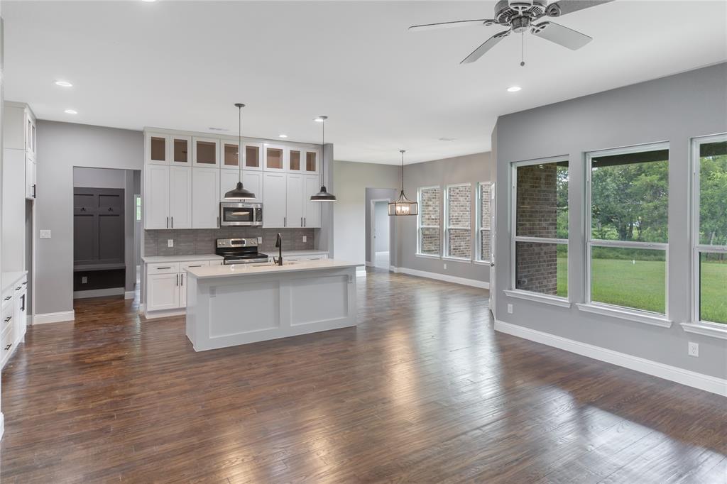 10560 Lago Vista Quinlan, TX 75474 - Photo 6 of 31 a view of kitchen with stainless steel appliances kitchen island wooden floor and window