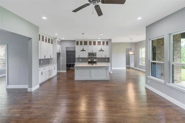 a view of a kitchen with a sink stainless steel appliances and cabinets