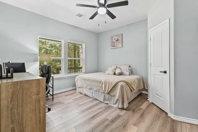 a bedroom with a bed and a desk