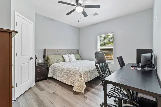 a bedroom with a bed a desk and chair