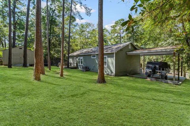 a view of a house with a backyard and sitting area
