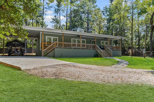 a front view of house with yard and green space