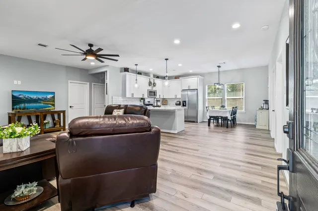 a living room with furniture and kitchen view