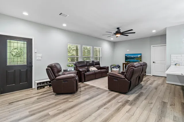 a living room with furniture and a large window