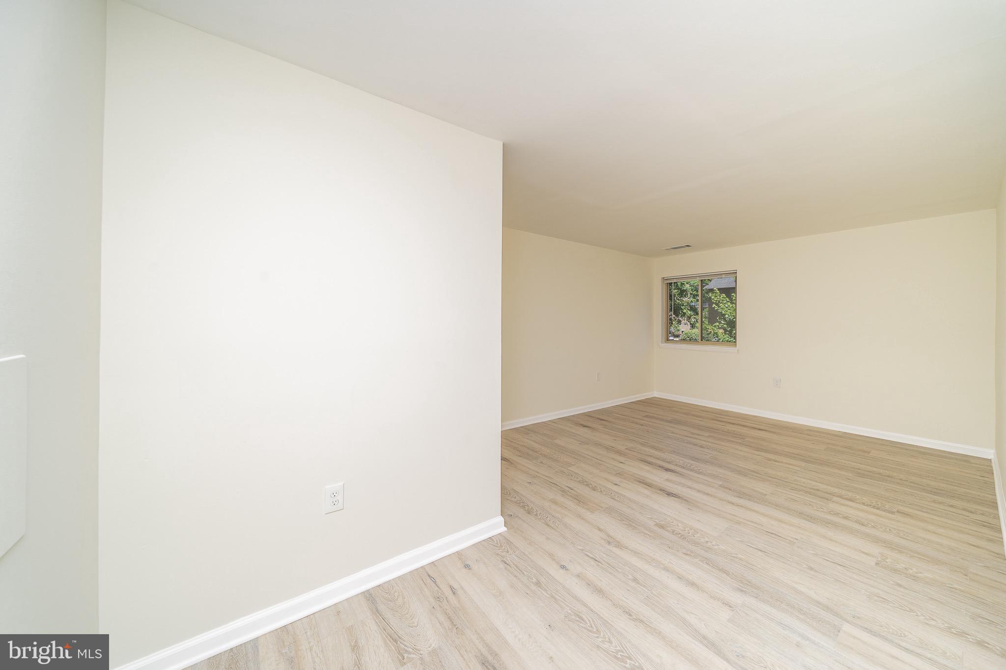 9910 Walker House Road, Unit 99104 Gaithersburg, MD 20886 - Photo 17 of 32 a view of an empty room and wooden floor