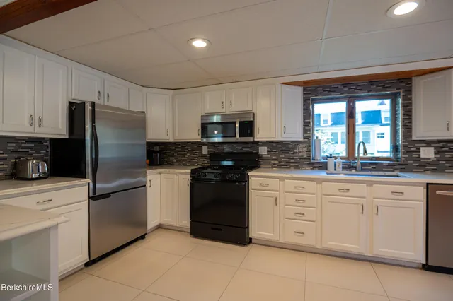 a kitchen with a sink stove and cabinets