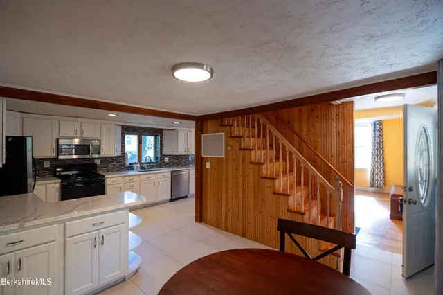 a kitchen with a sink a counter top space stainless steel appliances a counter space and cabinets