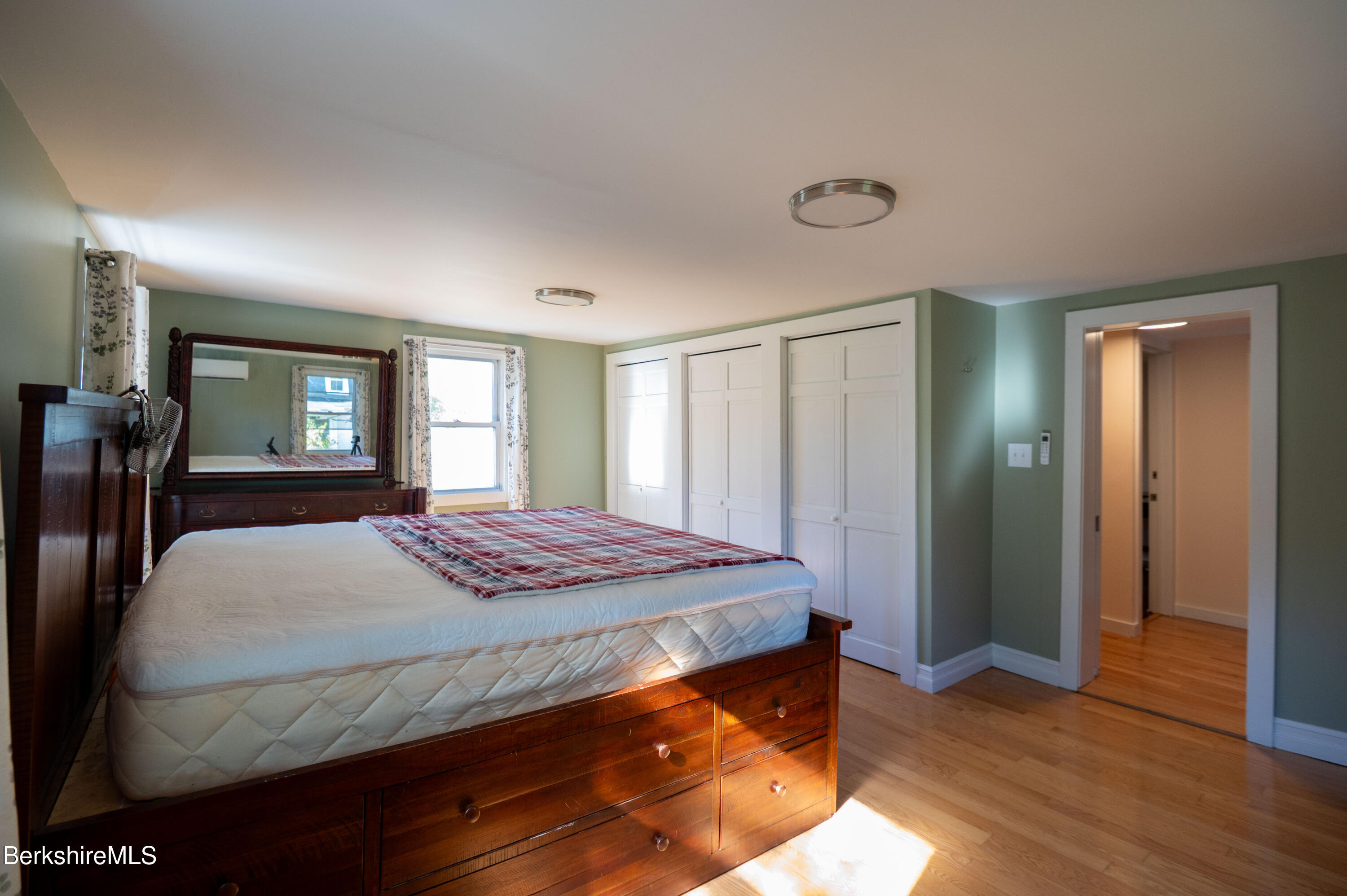 1600 Pleasant Street Lee, MA 01260 - Photo 21 of 26 a bedroom with a bed and wooden floor