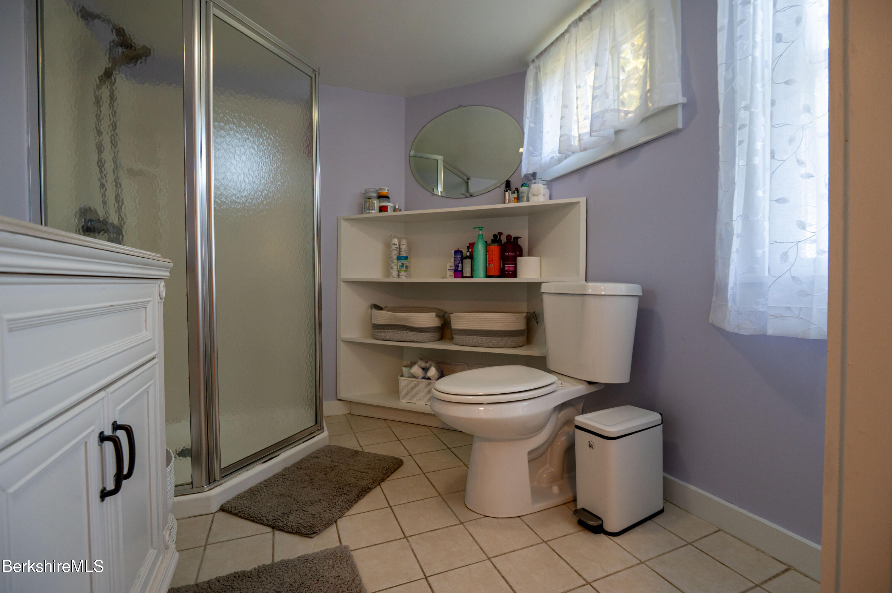 1600 Pleasant Street Lee, MA 01260 - Photo 25 of 26 a white toilet sitting next to a bathroom sink and vanity