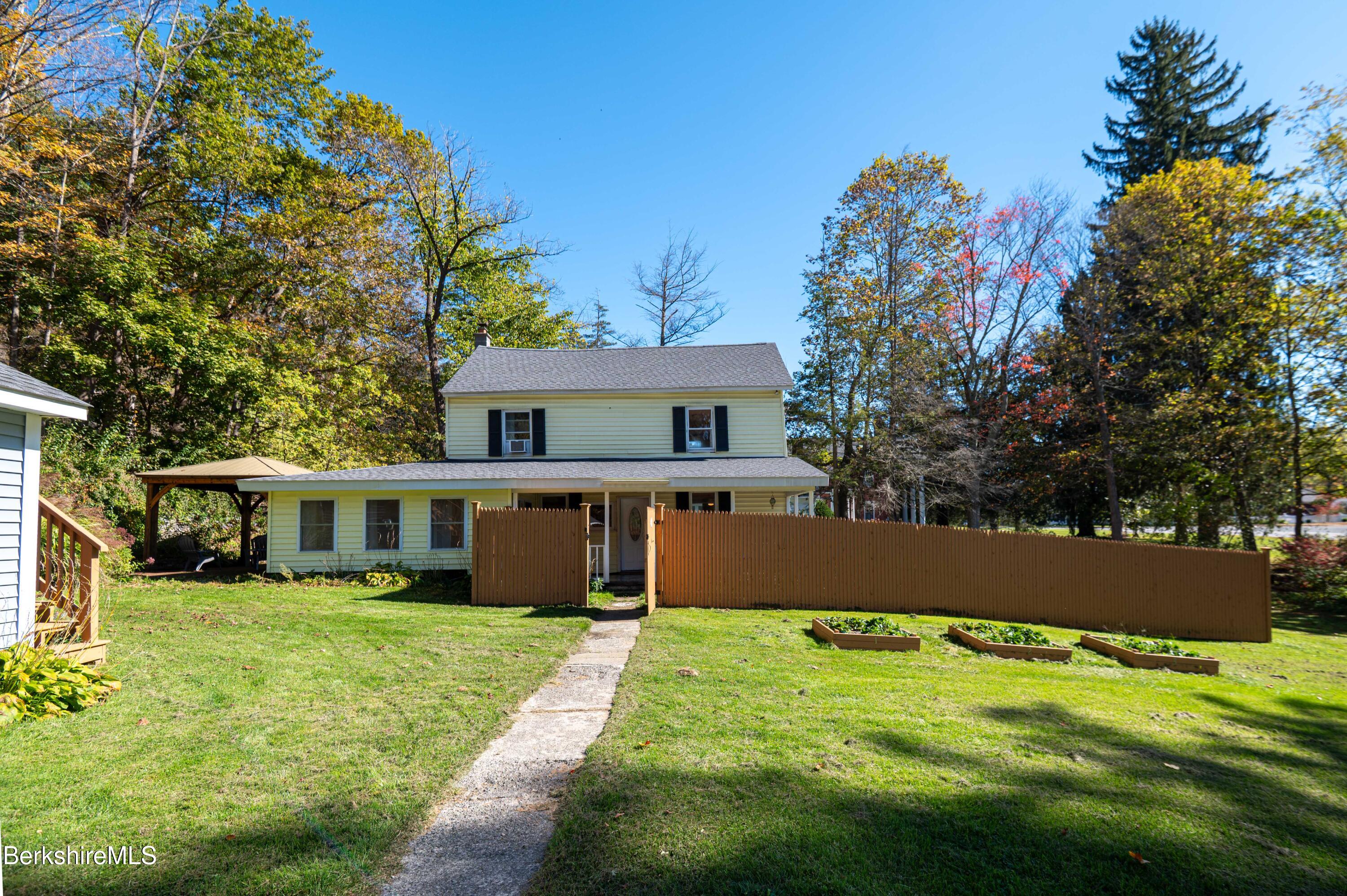 1600 Pleasant Street Lee, MA 01260 - Photo 3 of 26 a front view of a house with a yard