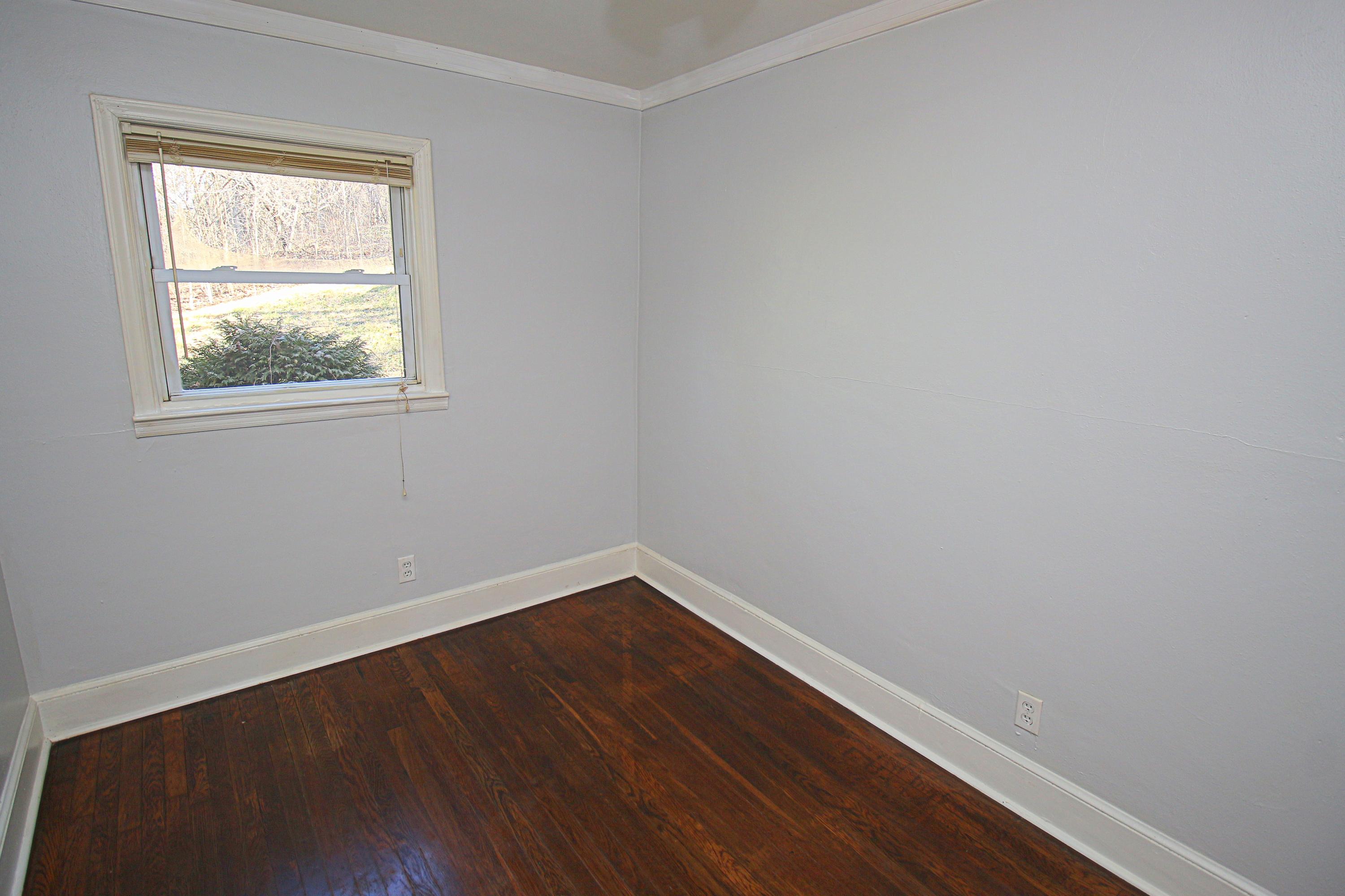 71 Rabbits Way Blue Ridge, VA 24064 - Photo 12 of 23 an empty room with wooden floor and windows