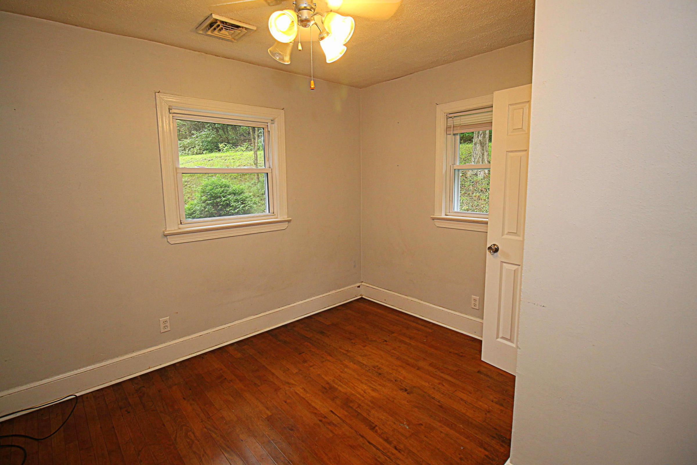 71 Rabbits Way Blue Ridge, VA 24064 - Photo 9 of 23 an empty room with wooden floor and windows