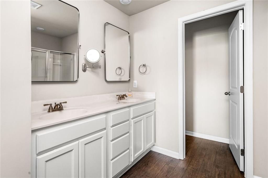 217 Whitetail Circle Canton, GA 30115 - Photo 24 of 30 a bathroom with a double vanity sink and mirror