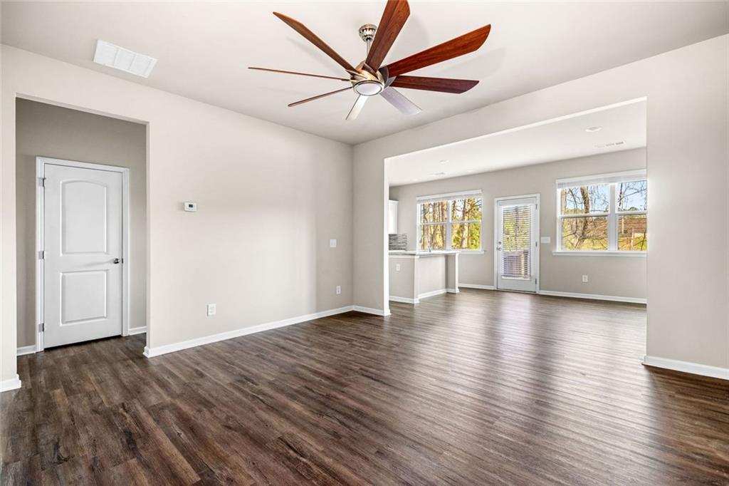 217 Whitetail Circle Canton, GA 30115 - Photo 9 of 30 an empty room with wooden floor chandelier and windows