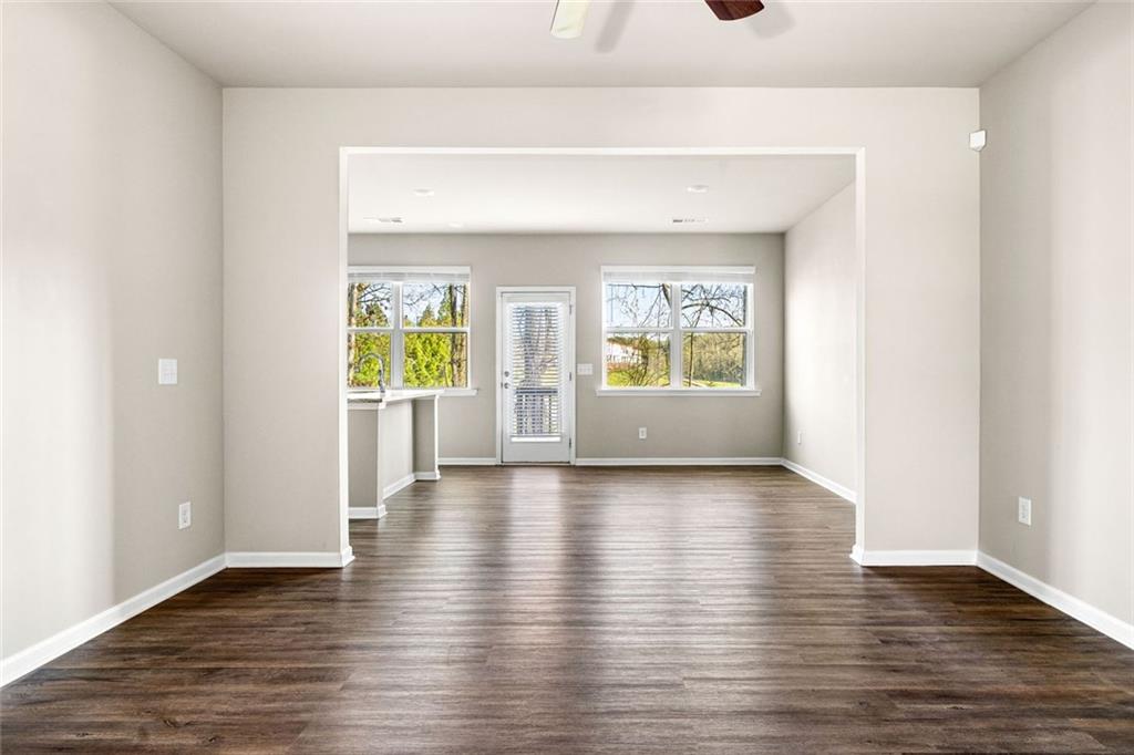 217 Whitetail Circle Canton, GA 30115 - Photo 10 of 30 a view of an empty room with wooden floor and a window