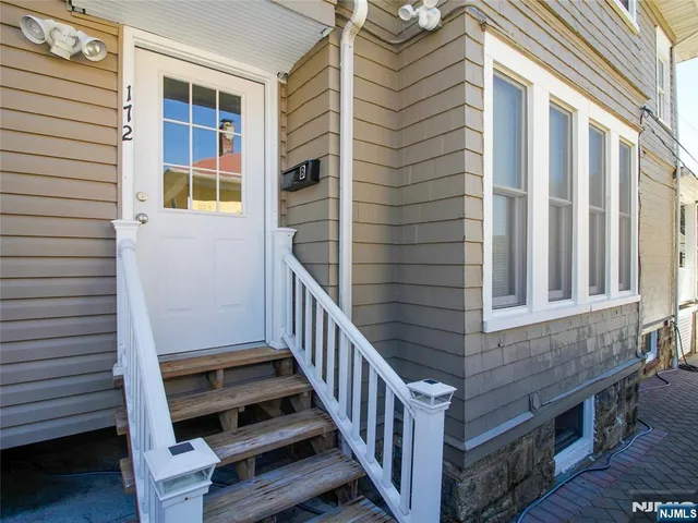 a view of a balcony with door and wooden floor
