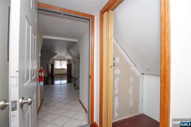 a view of a hallway with wooden floor windows and closet