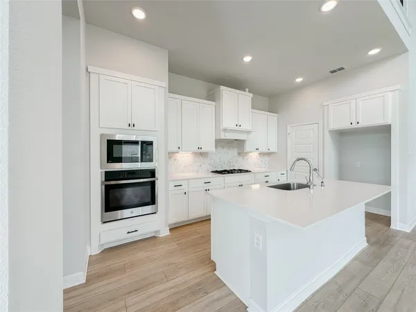 a kitchen with sink and cabinets