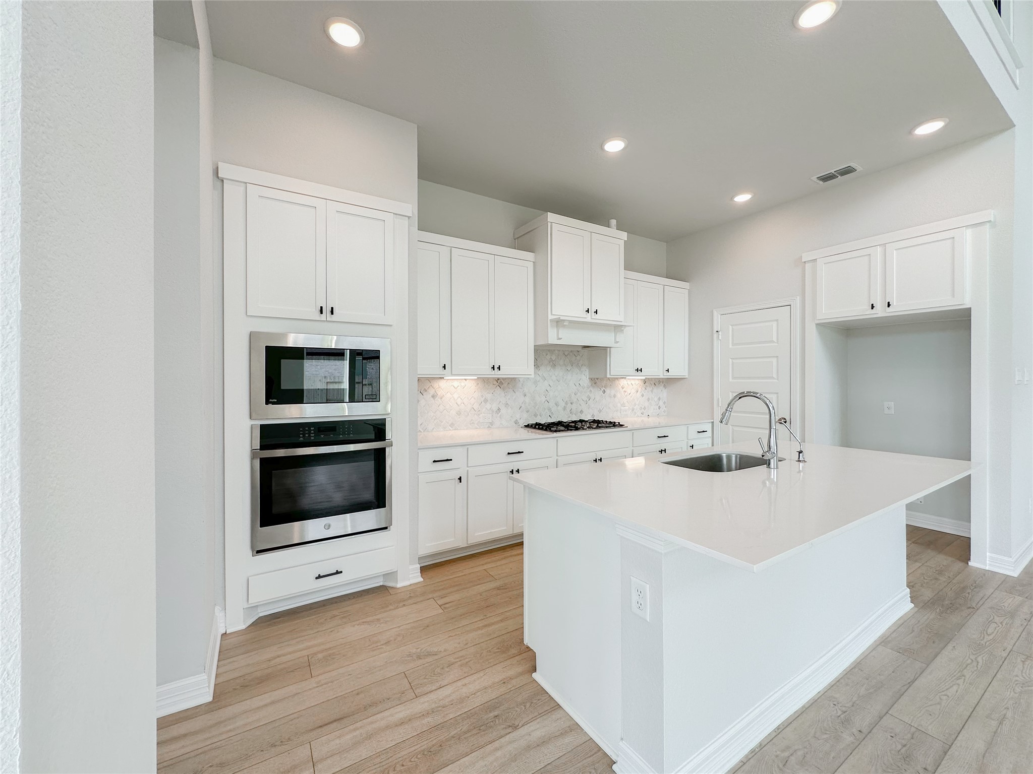 9411 Coleraine Court Tomball, TX 77375 - Photo 11 of 34 a kitchen with stainless steel appliances granite countertop a sink stove and refrigerator