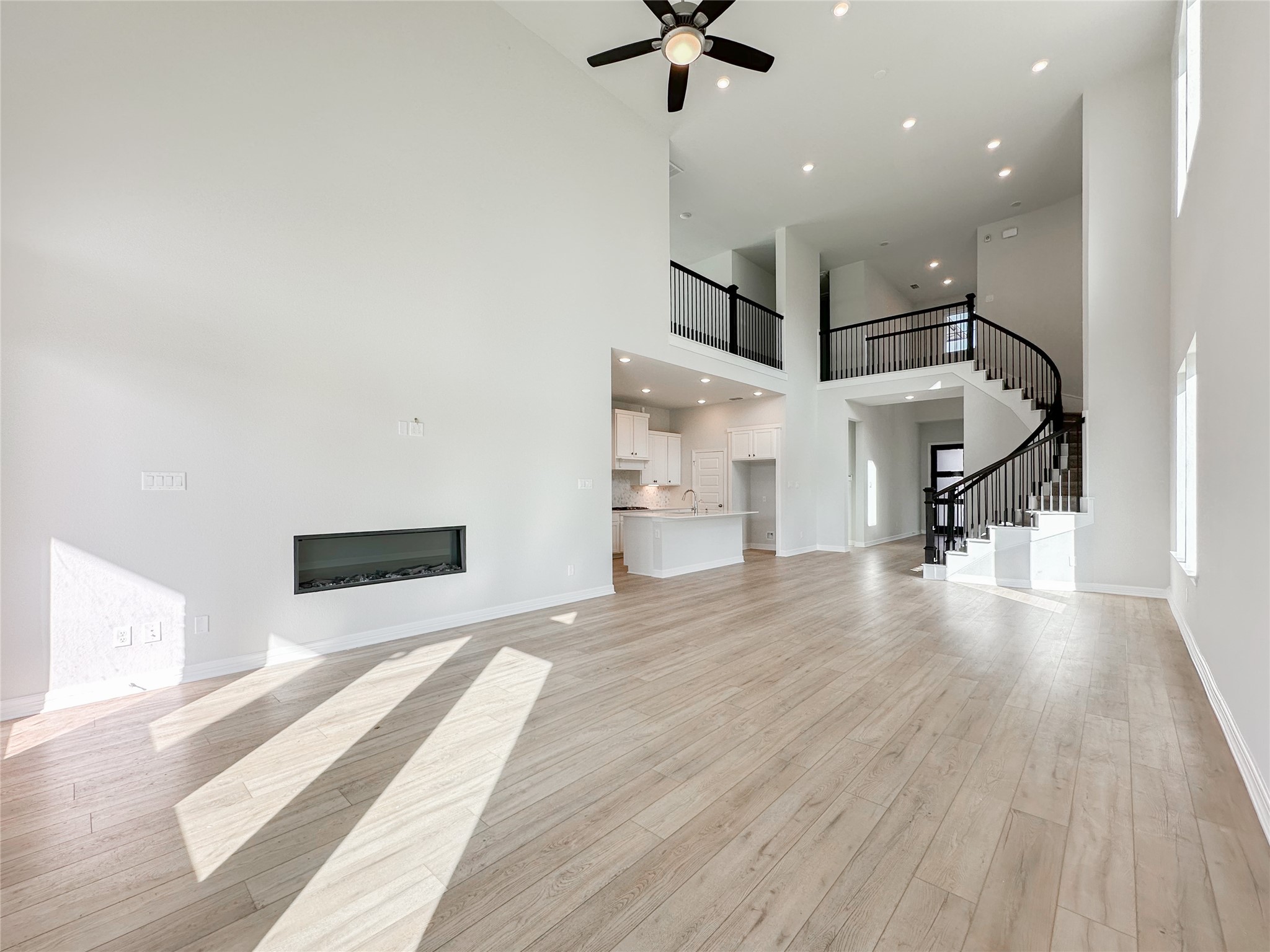 9411 Coleraine Court Tomball, TX 77375 - Photo 16 of 34 a view of a hallway with stairs and wooden floor