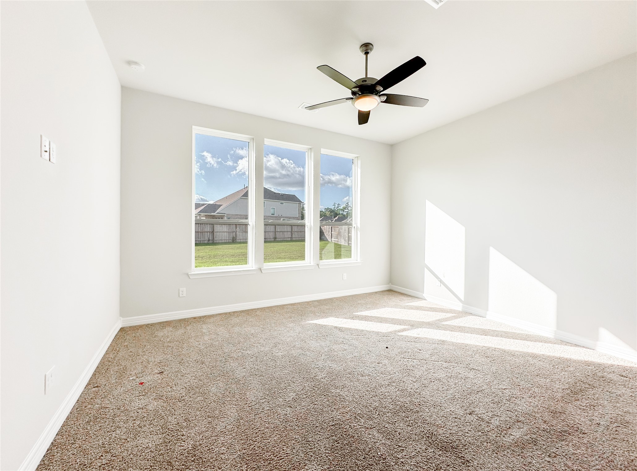 9411 Coleraine Court Tomball, TX 77375 - Photo 20 of 34 a view of a livingroom with a ceiling fan and window
