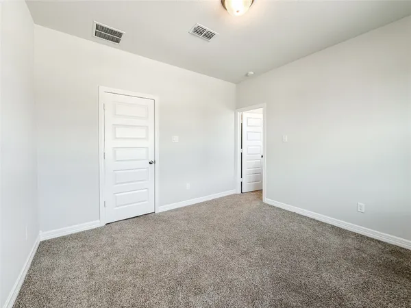 a view of a house with a big yard and large trees