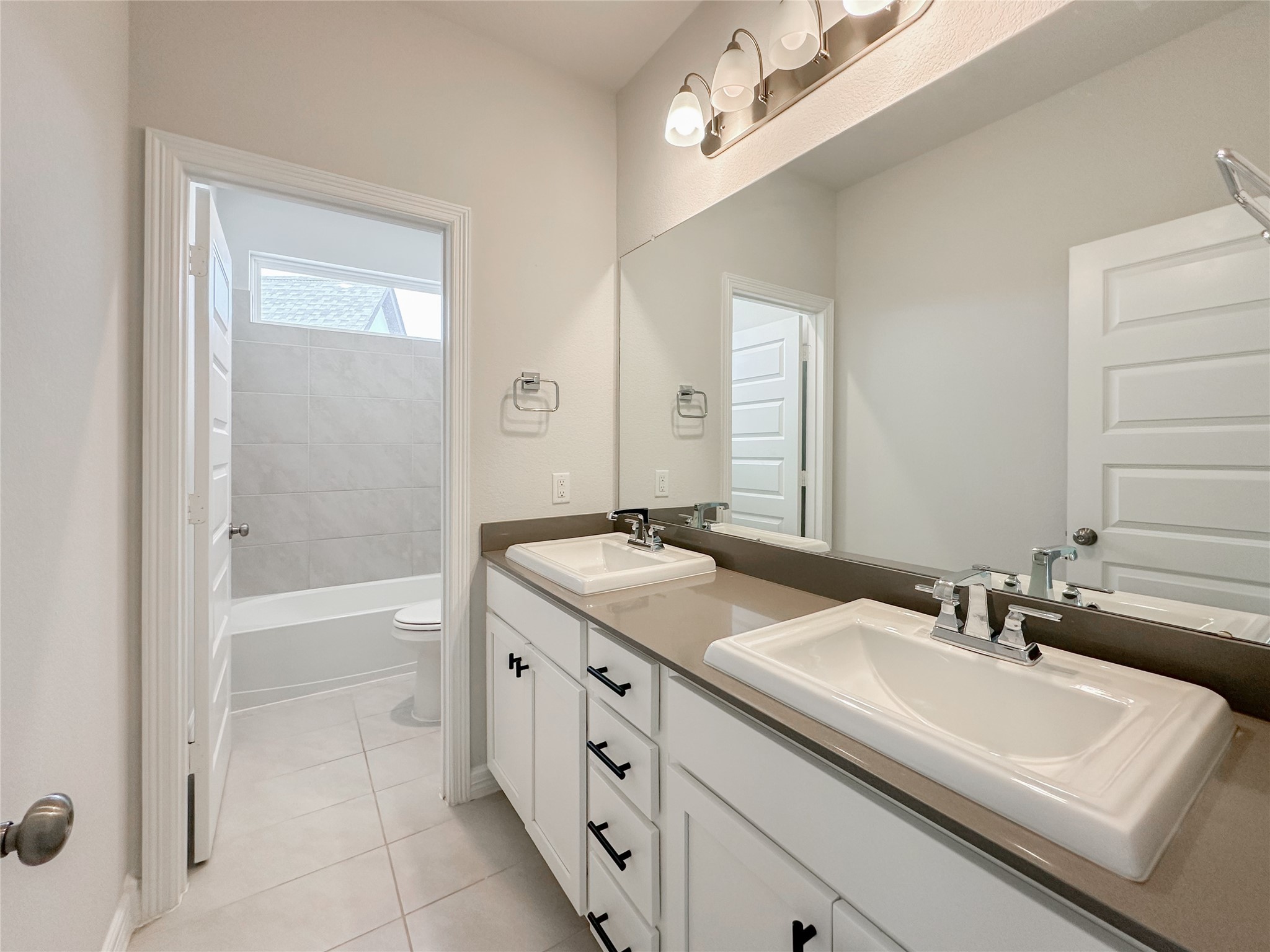 9411 Coleraine Court Tomball, TX 77375 - Photo 26 of 34 a bathroom with a sink double vanity granite tub and a mirror
