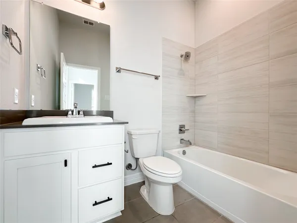a view of a hallway with wooden floor and a kitchen