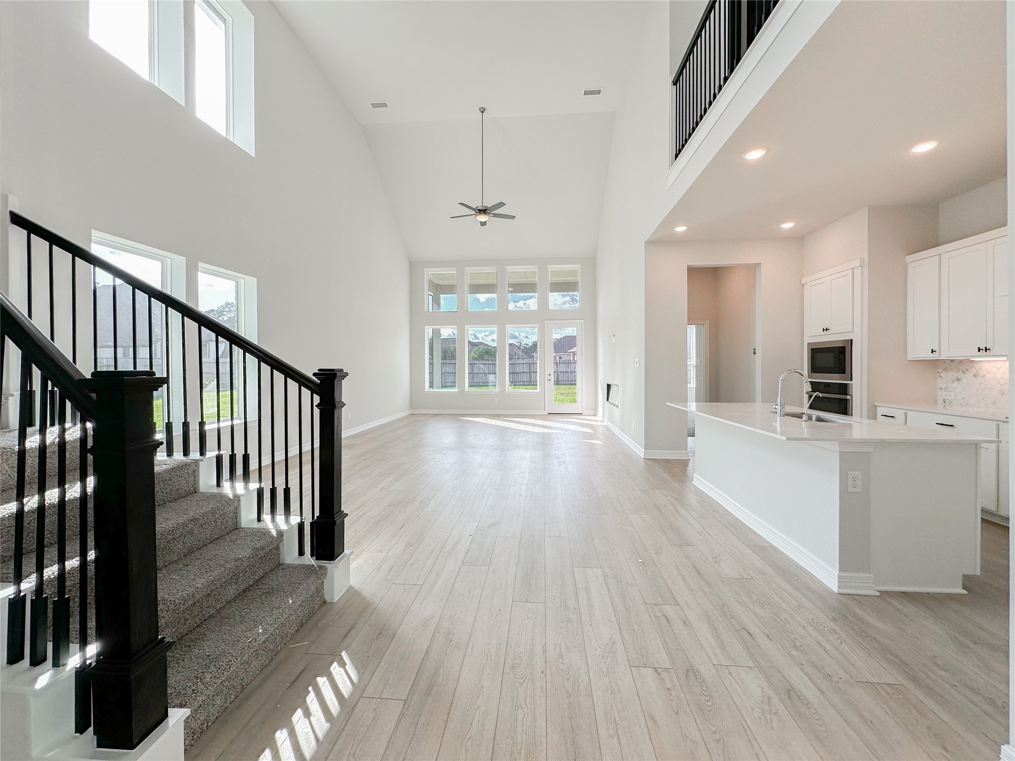 9411 Coleraine Court Tomball, TX 77375 - Photo 7 of 34 a view of a hallway with wooden floor and a kitchen