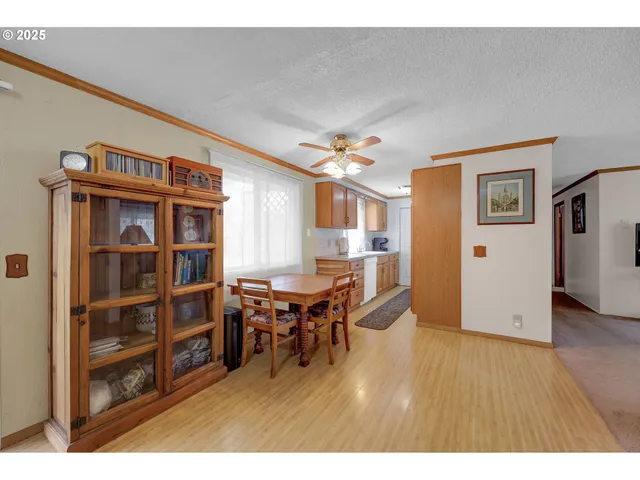 a dining room with furniture and wooden floor