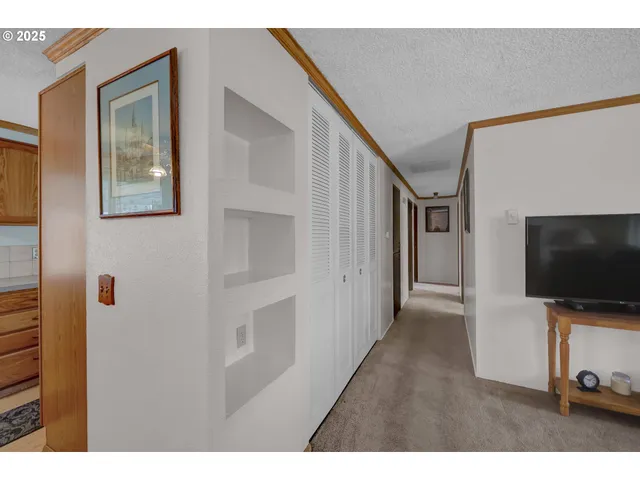 a view of a livingroom with wooden floor and staircase