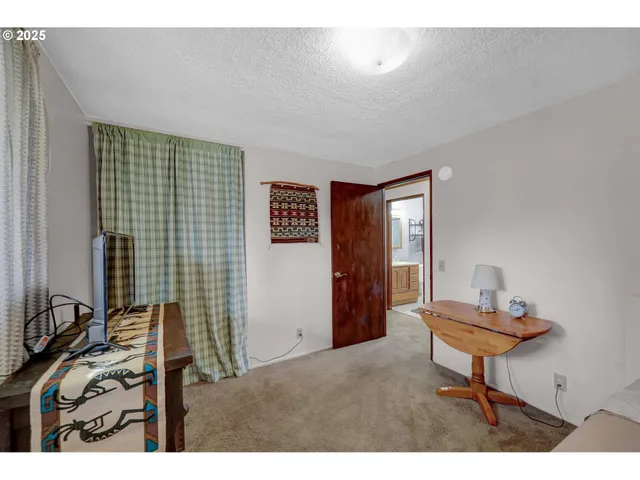 a view of a patio with a table chairs and a yard