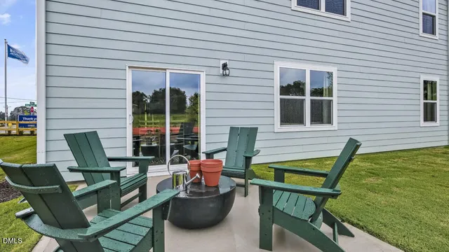 a view of a house with backyard and sitting area
