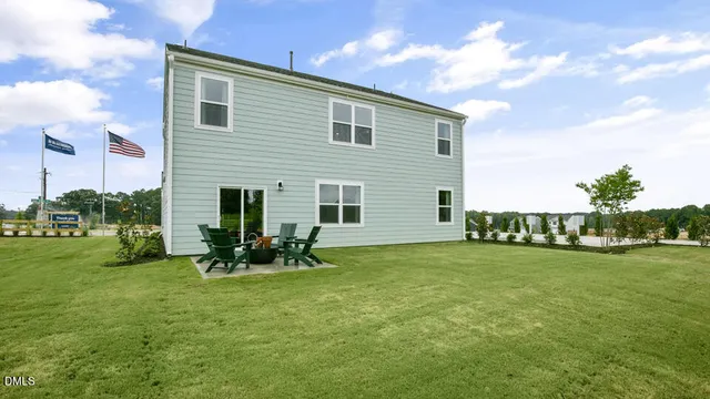 a backyard of a house with table and chairs